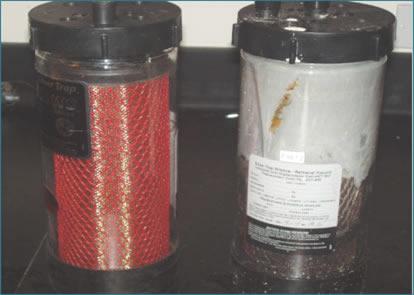 Two containers showing by-products for the silver recovery program.