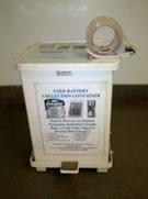 White metal bin with lid and roll of tape.
