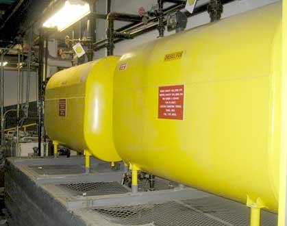 Two large oil containers shown in a storage facility.