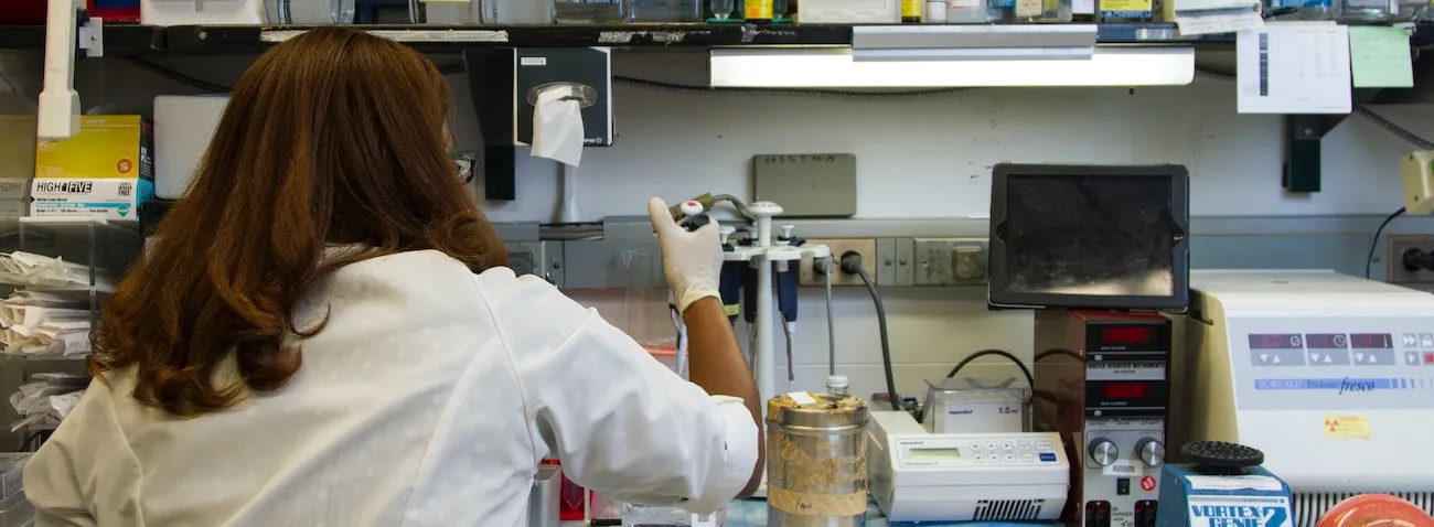 Chanelle Case Borden, Ph.D., a postdoctoral fellow in the National Cancer Institute's Experimental Immunology Branch, pipetting DNA samples into a tube for polymerase chain reaction, or PCR, a laboratory technique used to make multiple copies of a segment of DNA. Photo by National Cancer Institute on Unsplash.com.